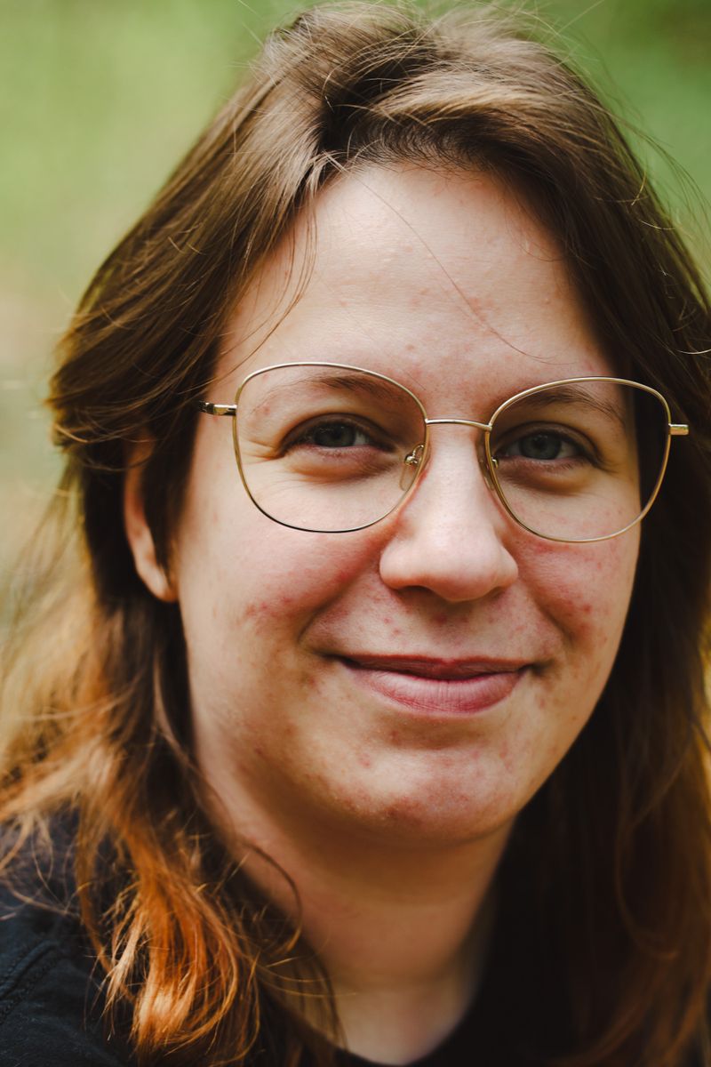 A person with a oval face shape wearing glasses