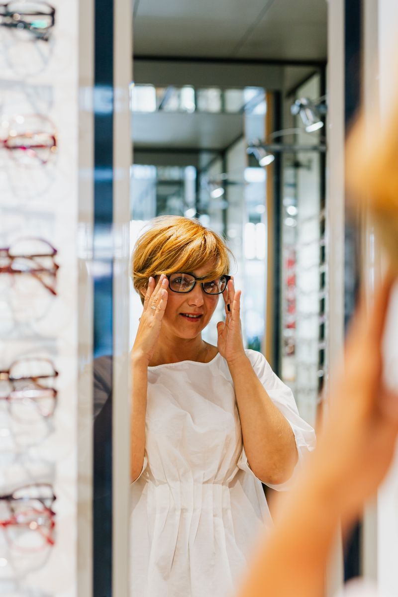 A woman trying on a pair of Meridian glasses at home